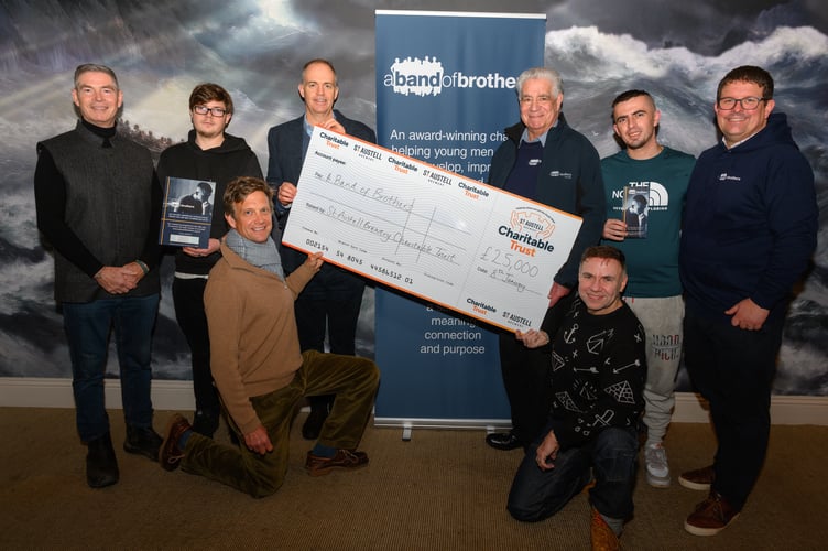 Brewery head of external affairs Piers Thompson presents a cheque to A Band of Brothers.